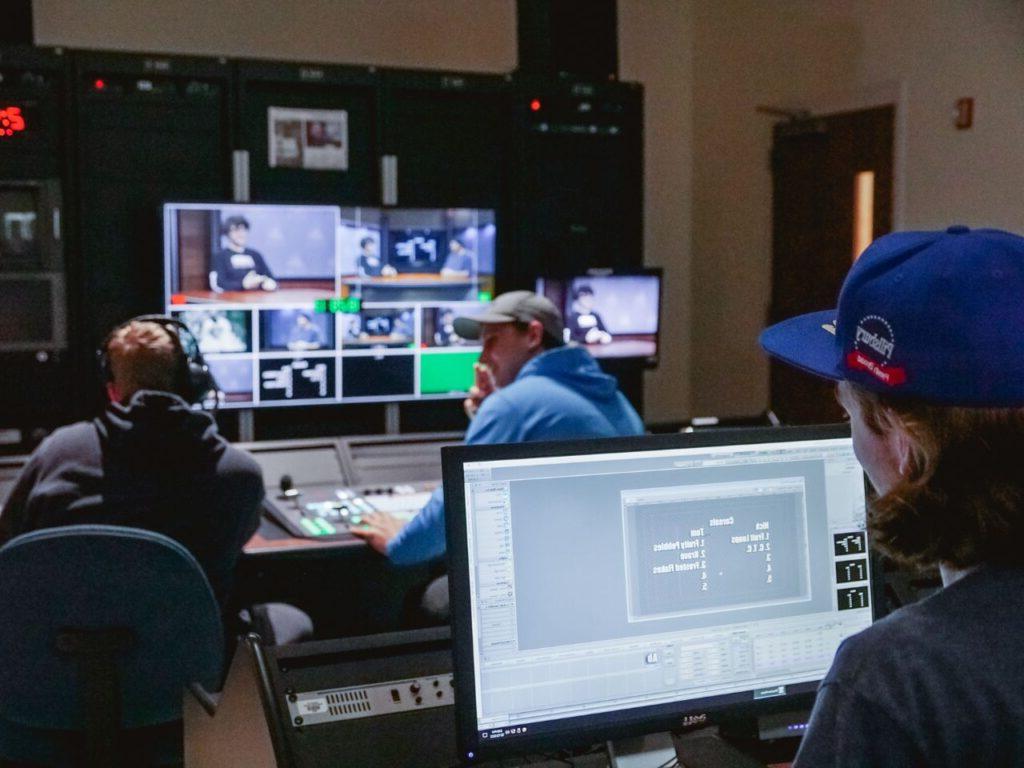 students in a studio behind computer screens