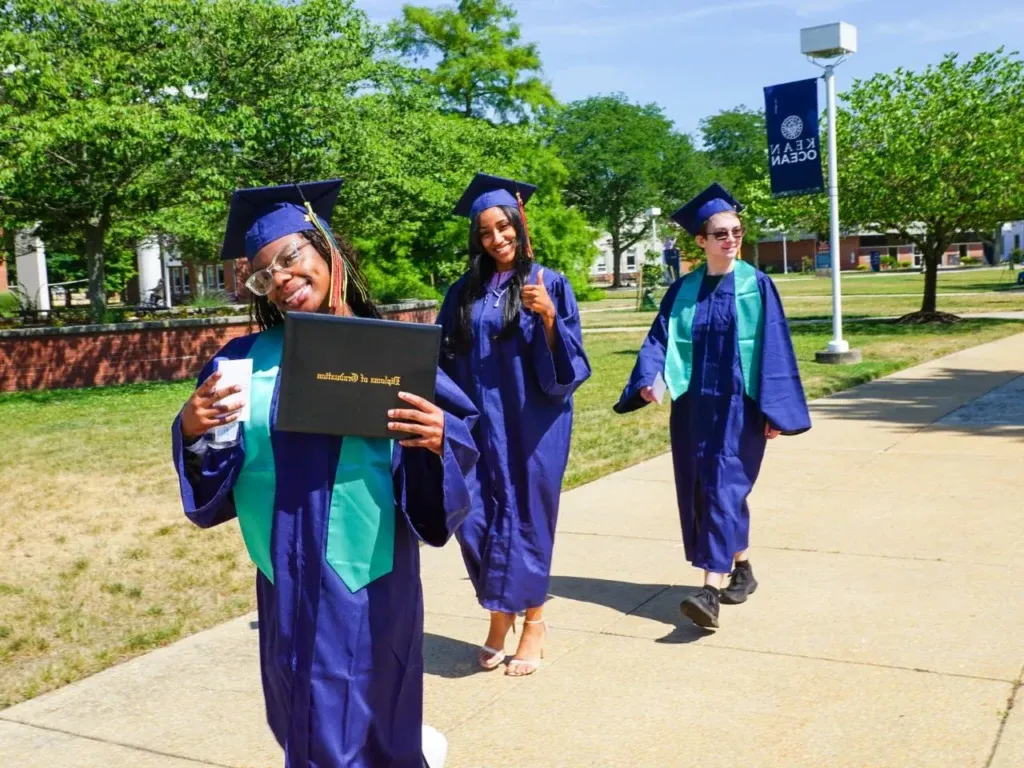 three students at graduation